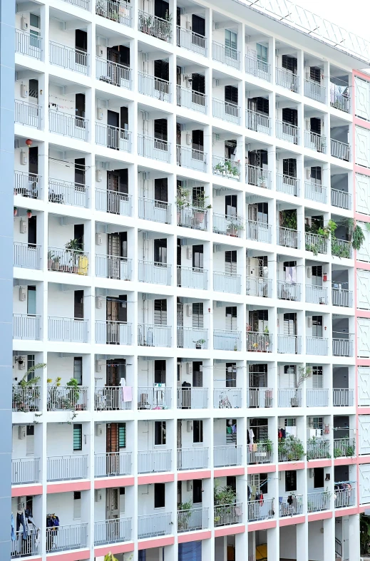 the large white building has many balconies