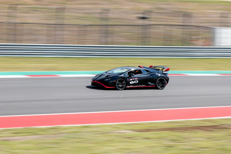 a sports car driving down a race track