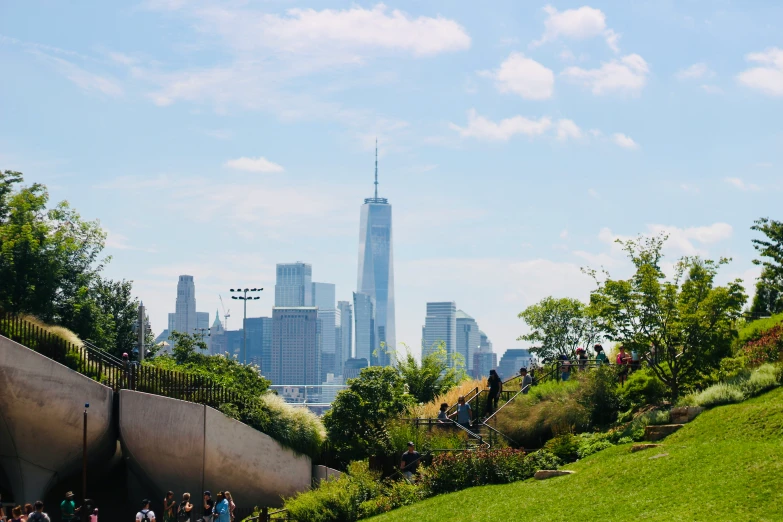 people on an elevated rail above a grassy field