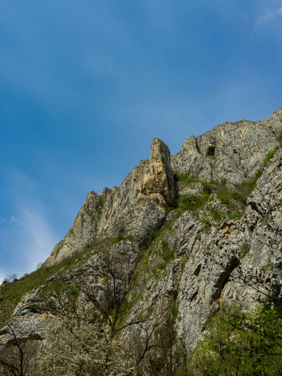 a view of some very tall mountains with rock formations