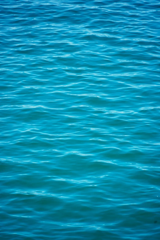 a large body of water that is blue with waves