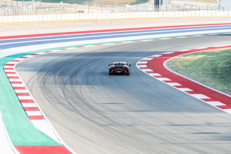 a racing car on a track with the driver driving