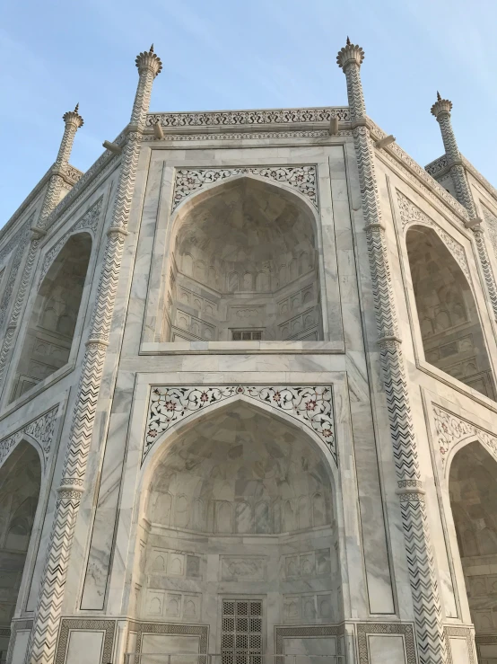 a large white arch of a building in the daytime