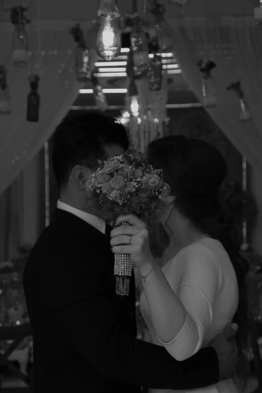 a man and woman that are hugging in front of a mirror