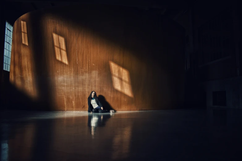 a person sitting on the ground with a laptop