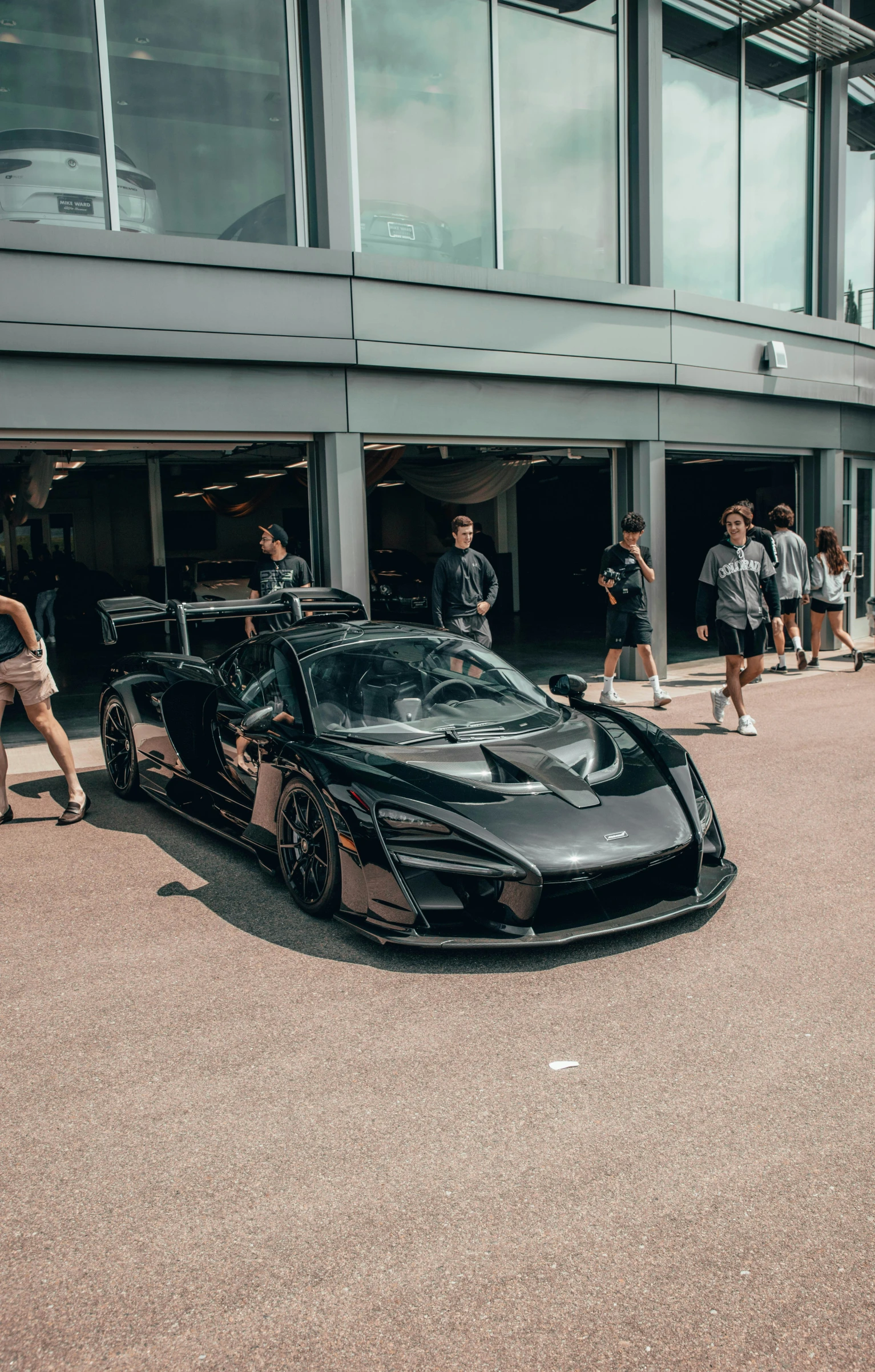 two sports cars sitting on the side of the road