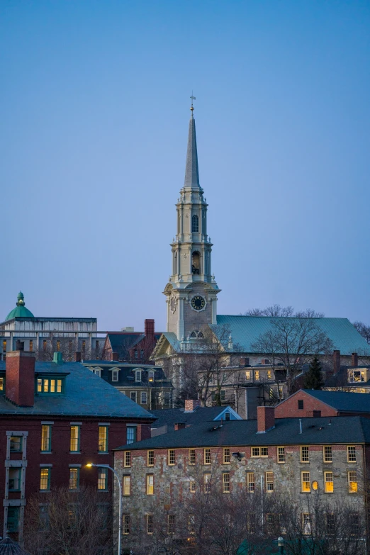 a building with a clock tower and some buildings in the background