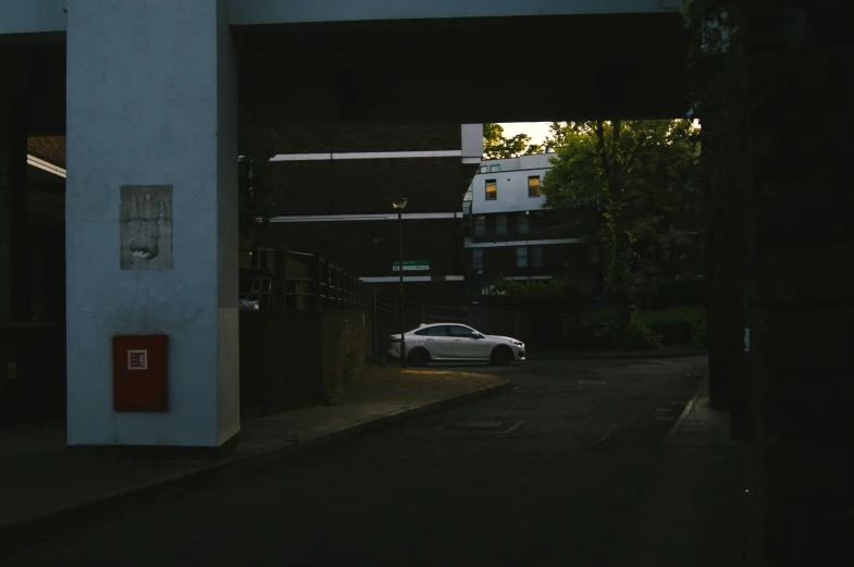 a car in the dark parked under a bridge