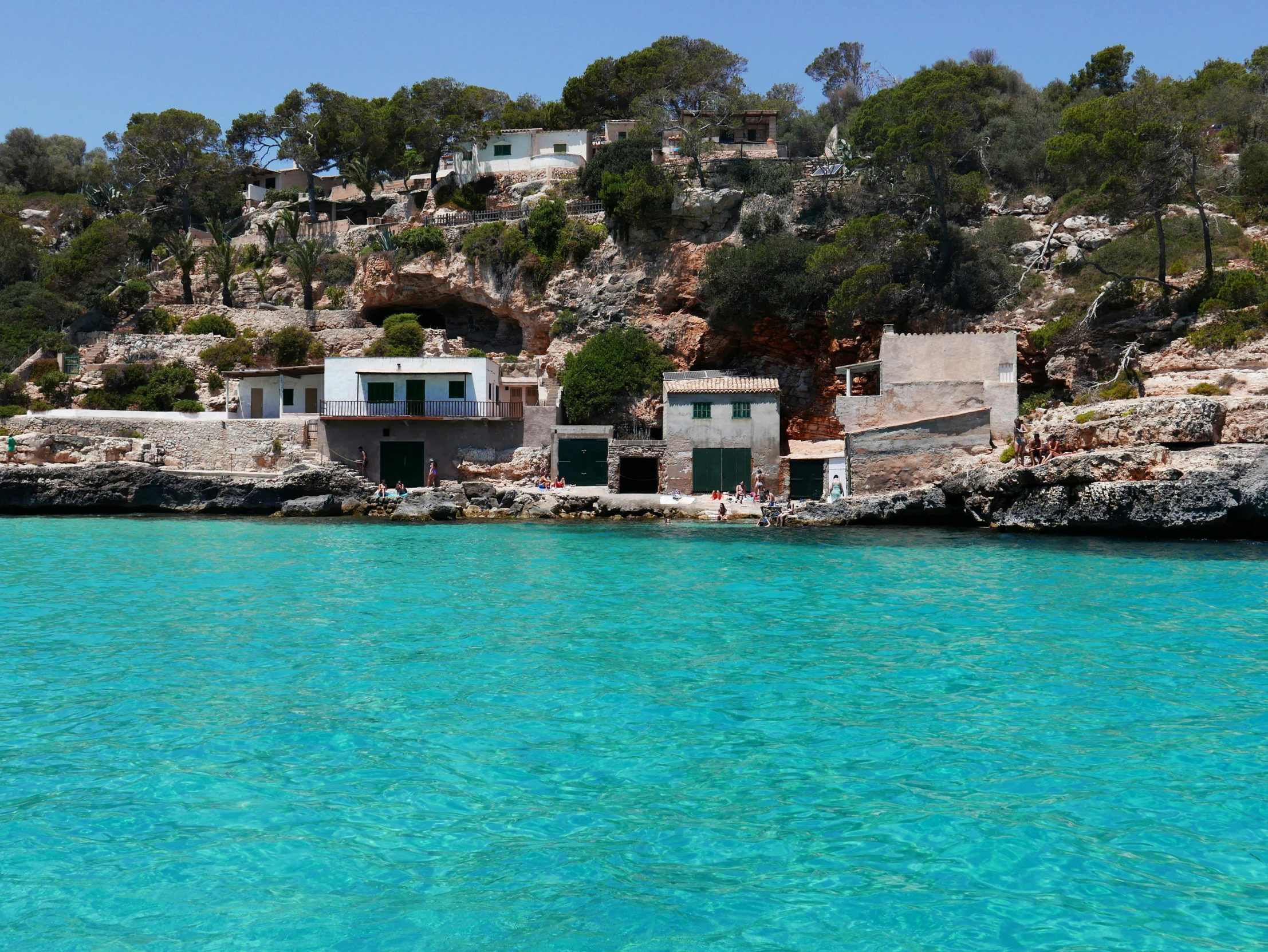 a small house sitting on top of a rocky cliff