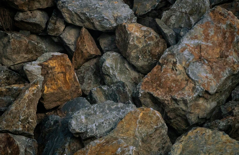 rocks that are stacked on each other with brown and black colored