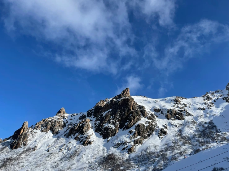 some snow mountain tops against the clear blue sky