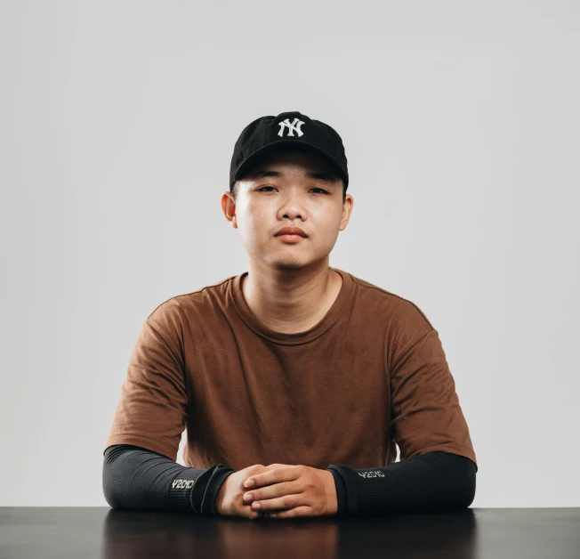 a man with a hat sitting at a table