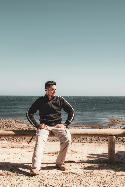 man holding on to the back of a surfboard