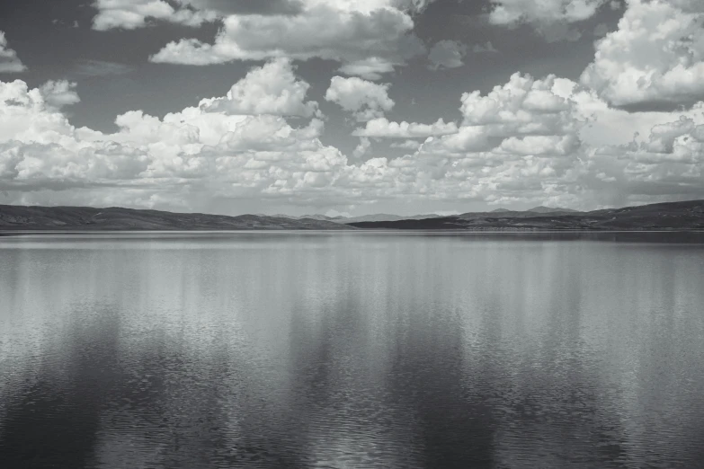 some clouds on a sunny day by some water