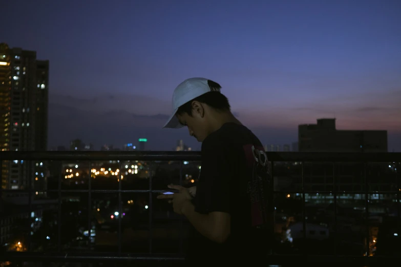 a person standing on a balcony at night