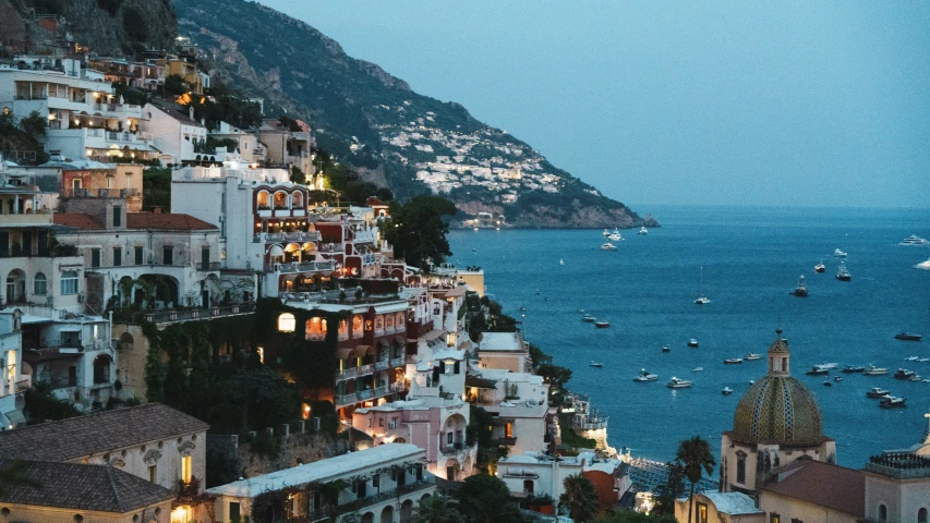 a city by the sea and boats floating on the water