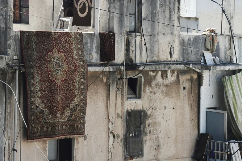 a large rug on a building near some electrical wires