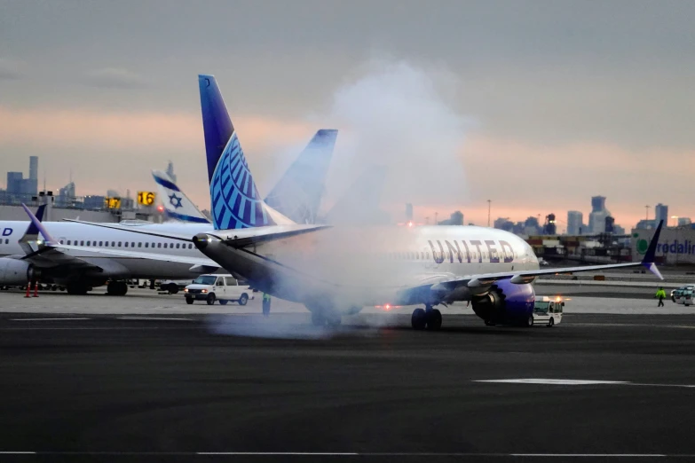 jet airliner with smoke as seen from the rear