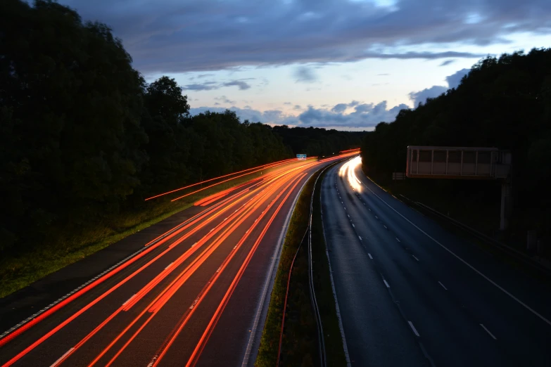 several cars moving on the highway with headlights coming out