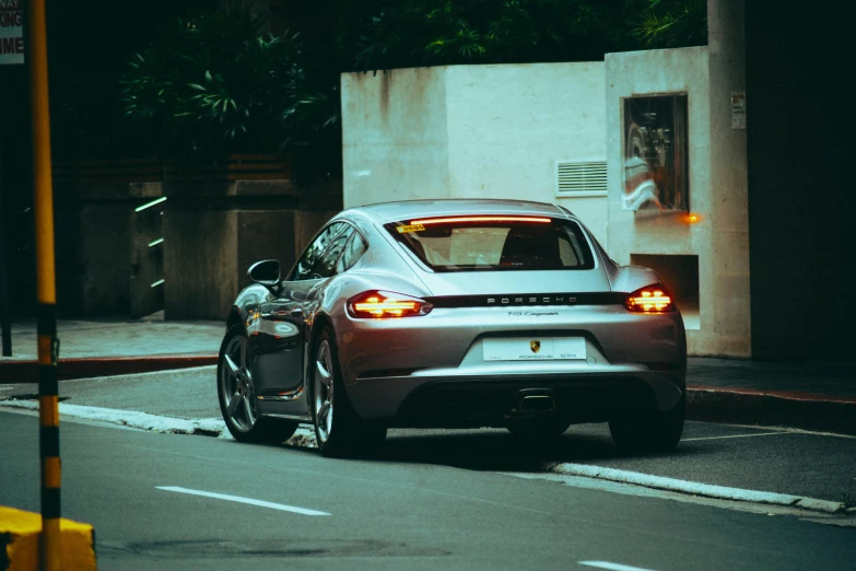 a silver car parked on the street next to a curb