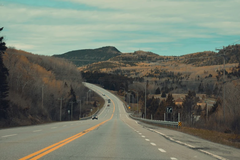 a view of a mountain road on the side of a hill