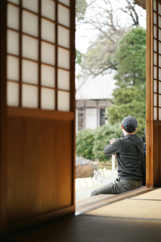 a person sitting on the floor in front of an open door