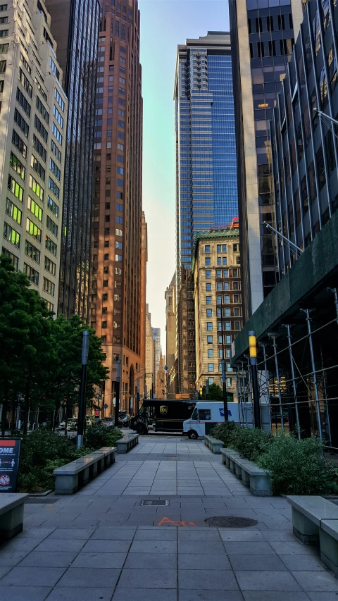 an empty city street with some buildings in the back