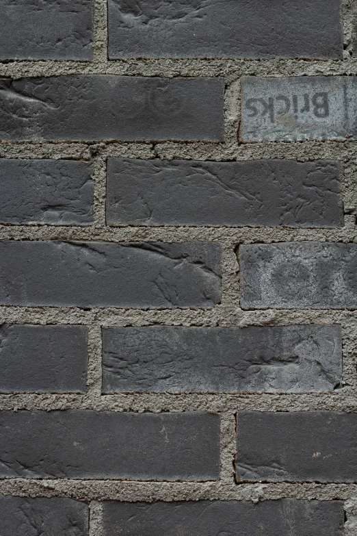 a black brick wall is in the midst of a close up s