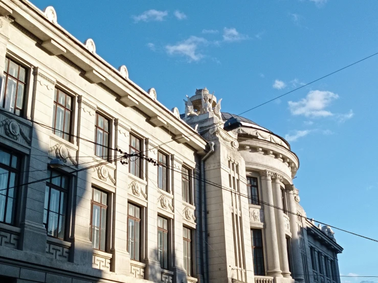 a large building with balconies next to a clock