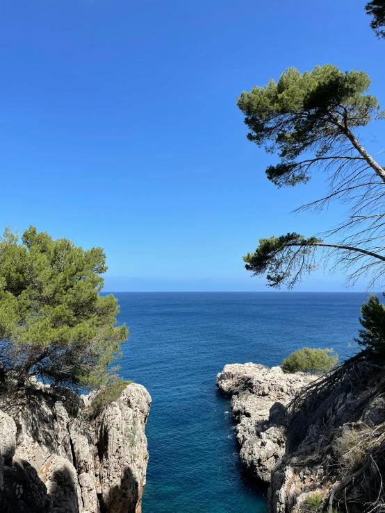 an ocean view is seen from a rocky outcropping