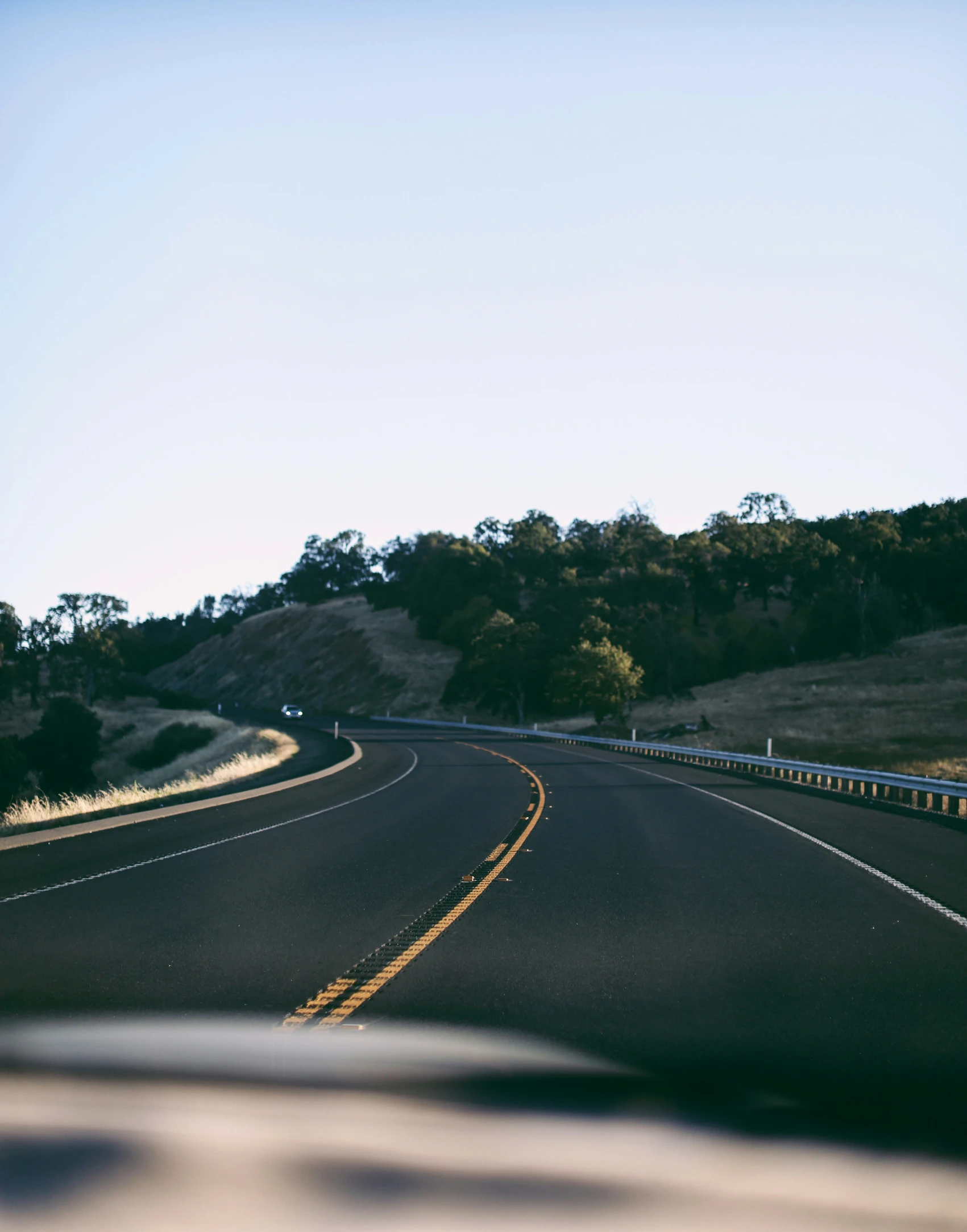 a curve in the road as seen from a vehicle