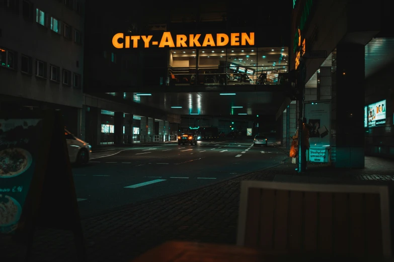 the city - arkadden neon sign lit up over a street