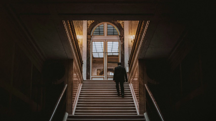 man walking down stairs at night or dawn