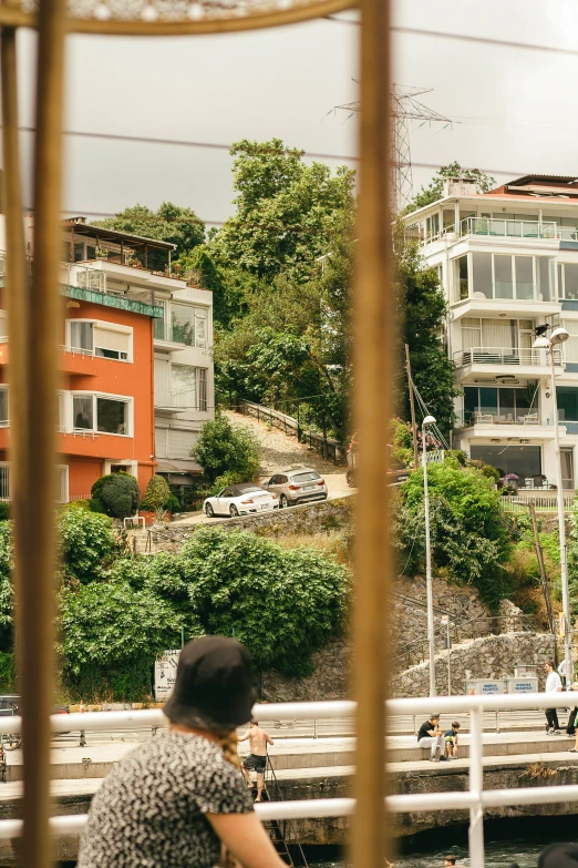 a woman is standing on the bridge and looking at the other people