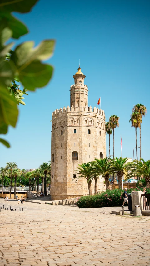 an old white tower in the middle of the beach