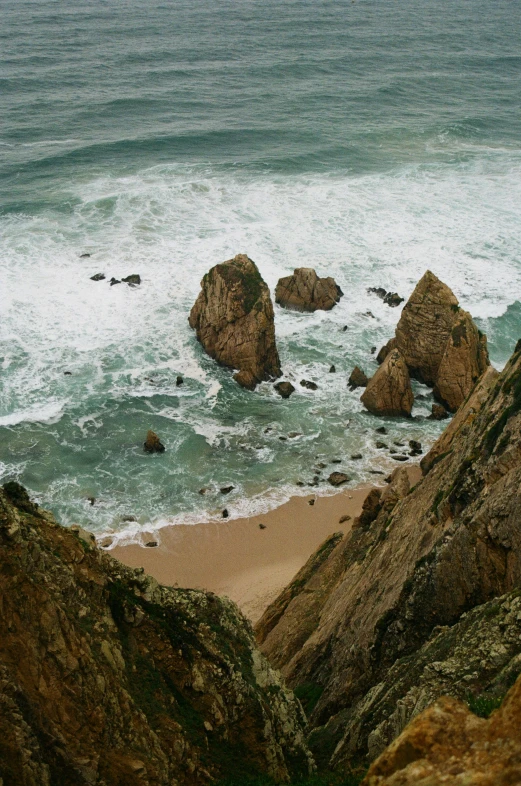 a view of a sea with the ocean and large rocks