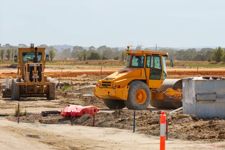 a small bulldozer is shown next to another vehicle