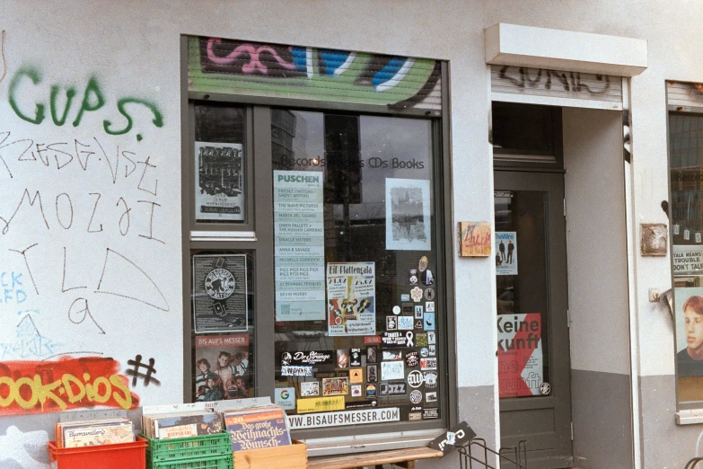 a graffiti - covered building that is full of newspaper