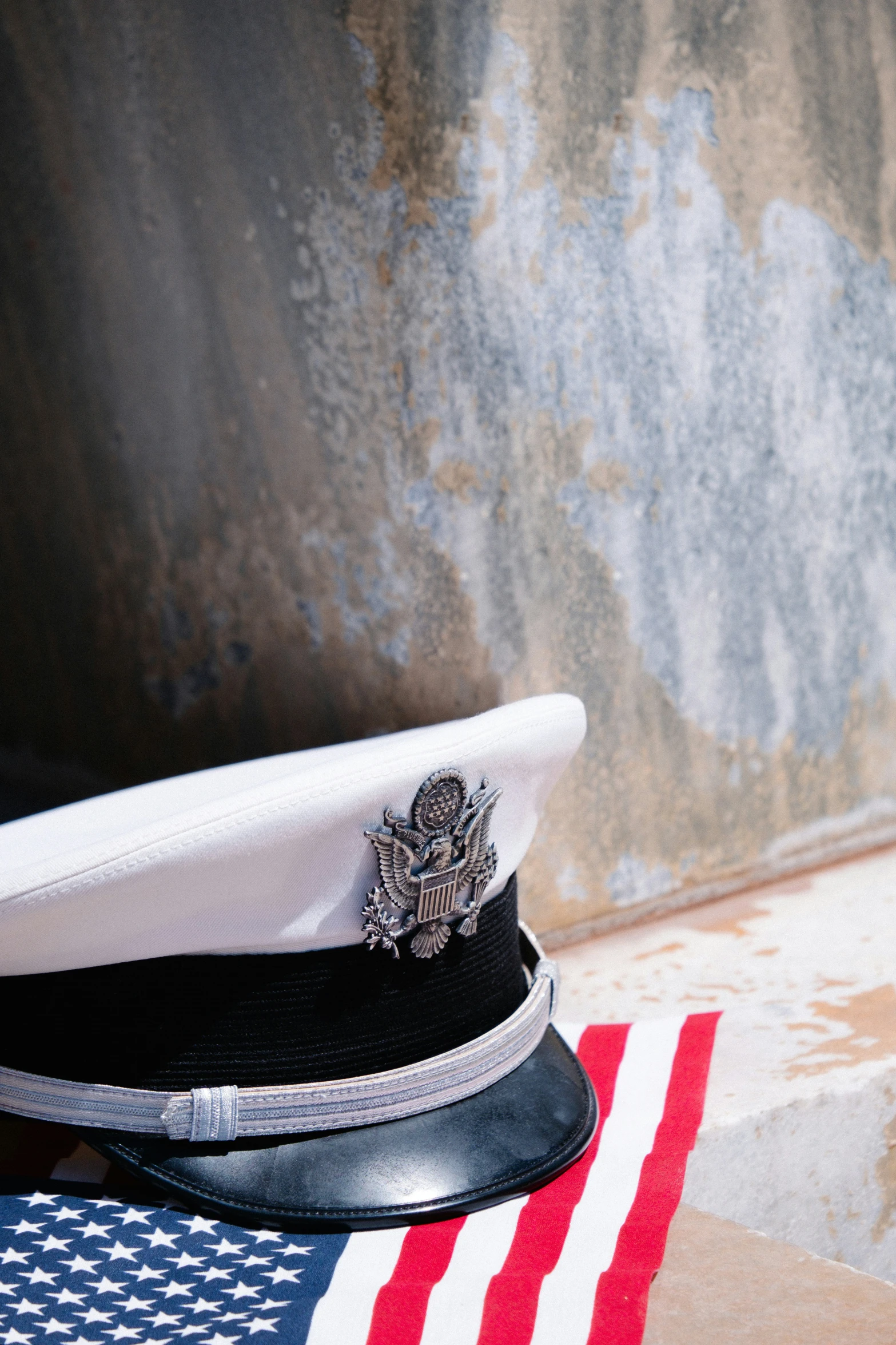 a navy cap on top of an american flag