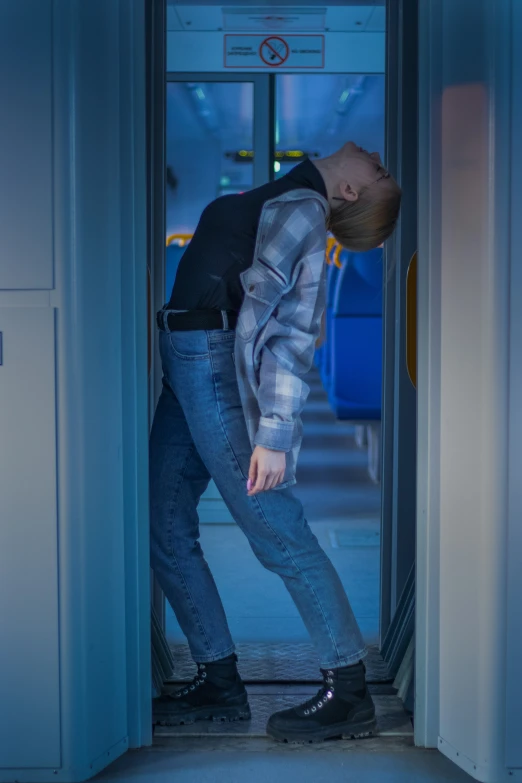 a man walking out of a building in blue light