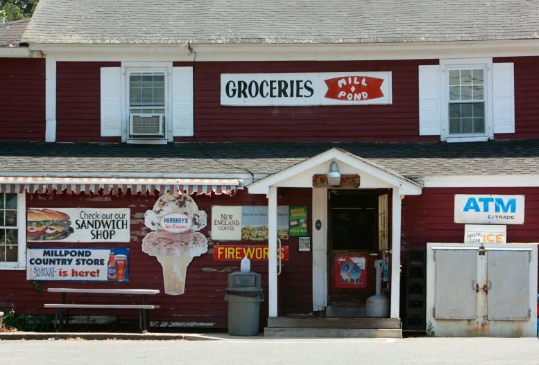 a red building with some signs hanging from it's roof