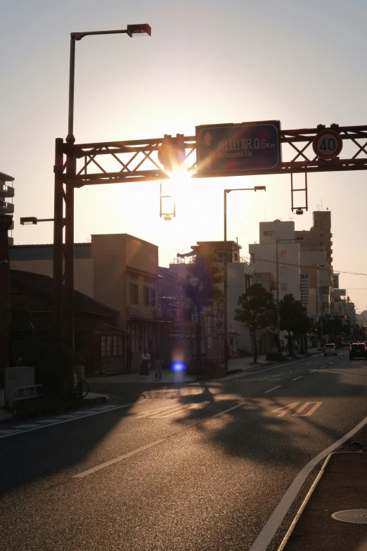 sunset over a city street and traffic lights