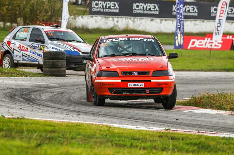 two cars driving around a track on a track