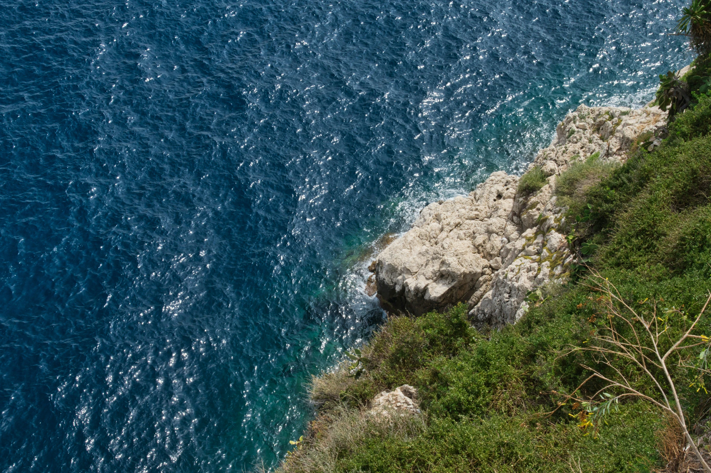 a cliff side near a body of water