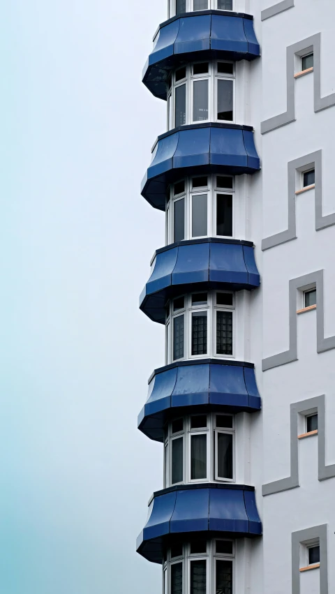 an elaborate blue and white building with a clock on the side