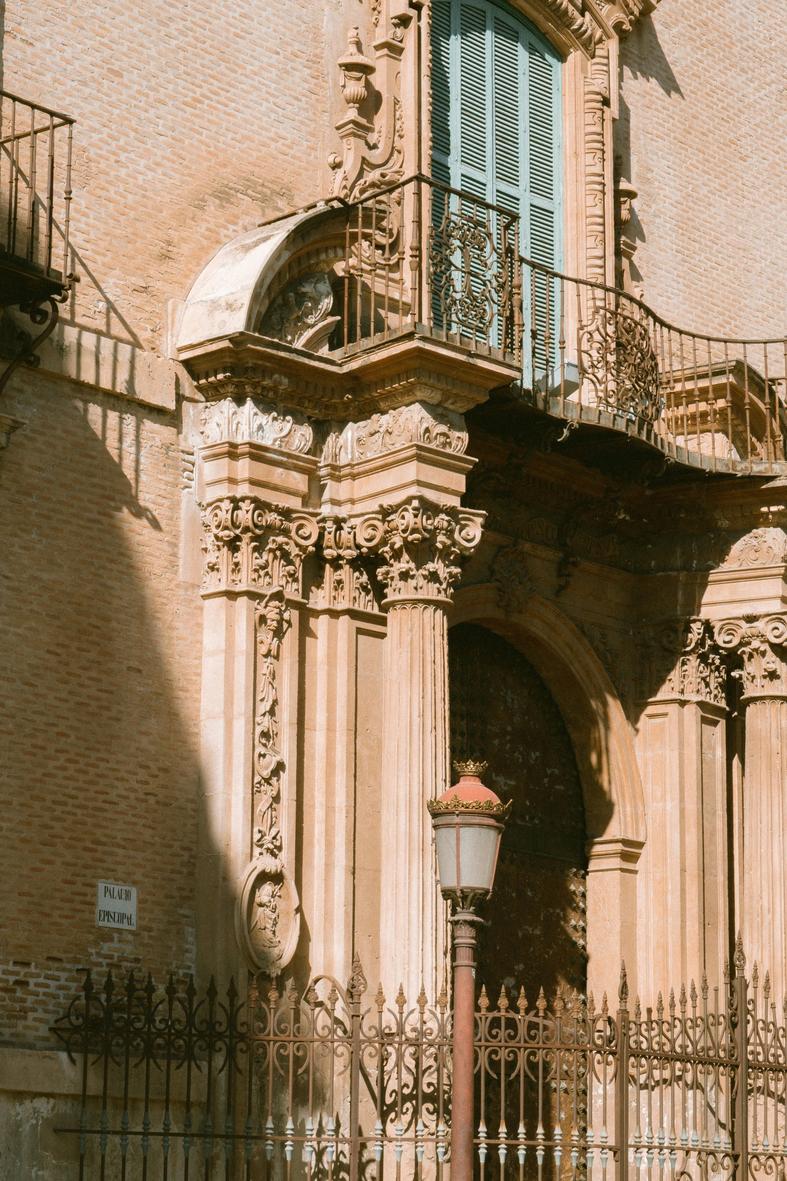 an elaborate building with ornate iron fence on it's side