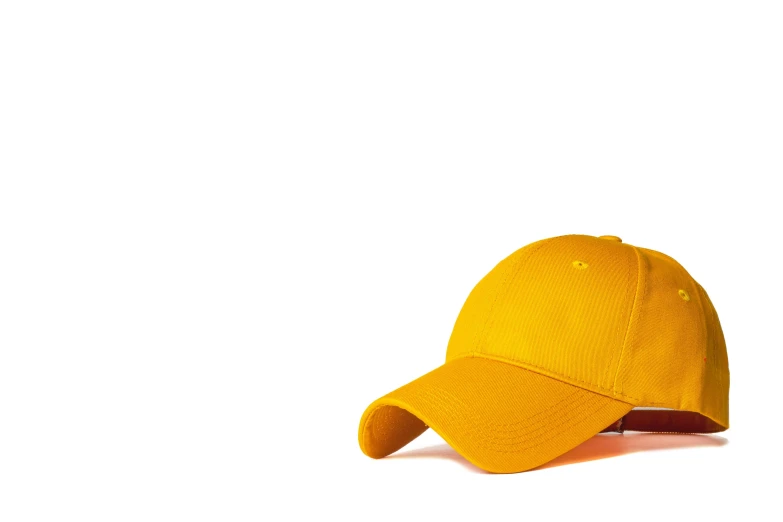 an orange hat sits on a white surface