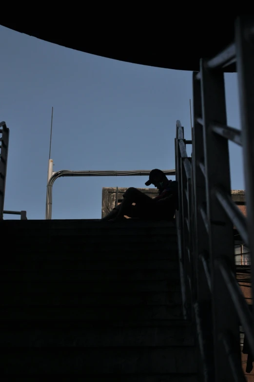 a man is sitting on the steps to watch soing