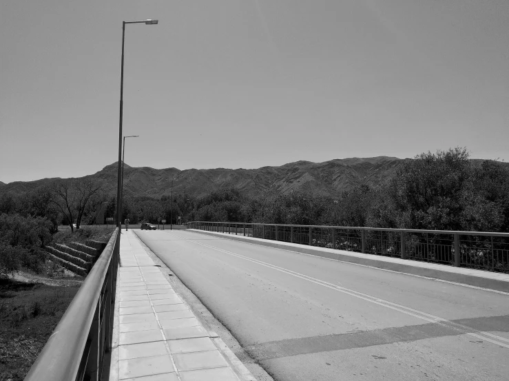 the view from an empty bridge into the mountain range