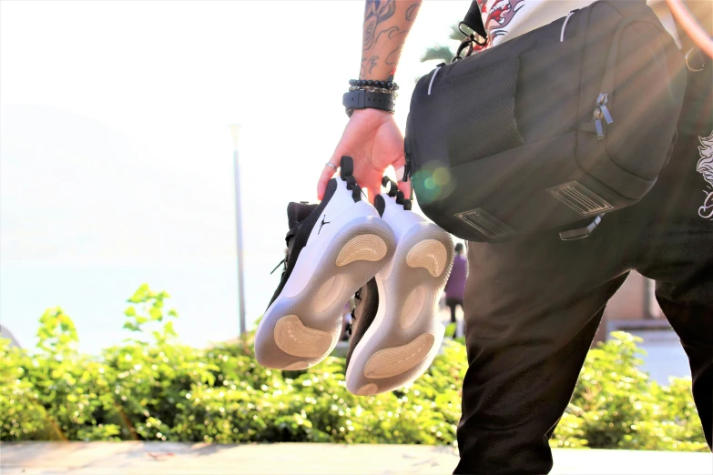 a person holding some big, shiny white shoes